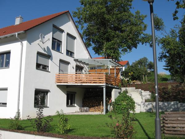 Balkonanbau in verzinkter Ausführung mit Geländer und teilweiser                          Überdachung mit Verglasung